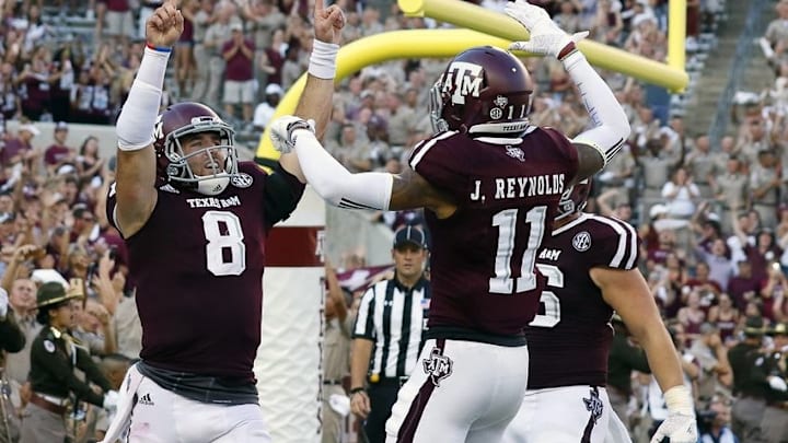 Sep 3, 2016; College Station, TX, USA; Texas A&M Aggies quarterback Trevor Knight (8) points skyward following his one-yard touchdown run in overtime against the UCLA Bruins. Texas A&M won 31-24. Mandatory Credit: Ray Carlin-USA TODAY Sports