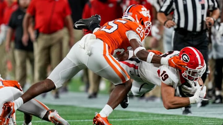 Sep 4, 2021; Charlotte, North Carolina, USA; Georgia Bulldogs tight end Brock Bowers (19) dives with the catch covered by Clemson Tigers safety Jalyn Phillips (25) during the first quarter at Bank of America Stadium. Mandatory Credit: Jim Dedmon-USA TODAY Sports