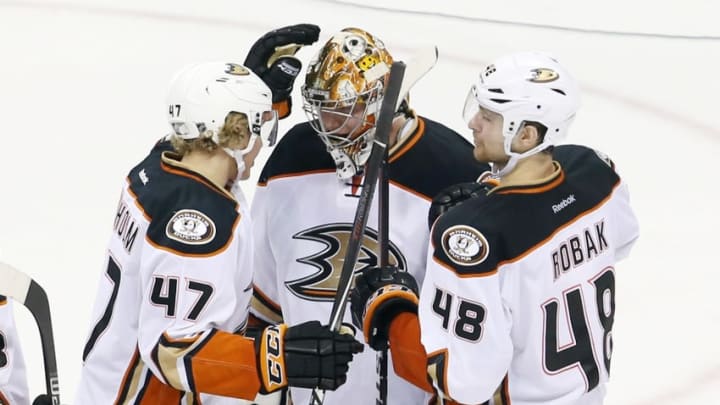 Dec 13, 2014; Winnipeg, Manitoba, CAN; Anaheim Ducks defenceman Hampus Lindholm (47) and defenceman Colby Robak (48) celebrate with goalie Frederik Andersen (31) after the game against the Winnipeg Jets at MTS Centre. Anaheim wins 4-1. Mandatory Credit: Bruce Fedyck-USA TODAY Sports