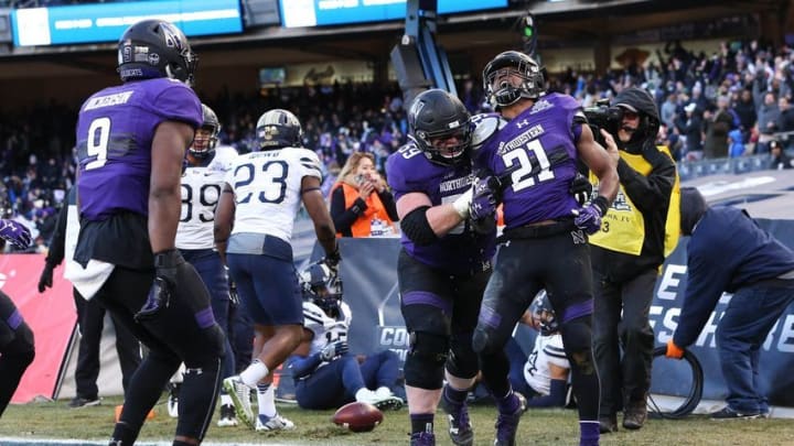 Dec 28, 2016; Bronx, NY, USA; Northwestern Wildcats running back Justin Jackson (21) celebrates his touchdown against the Pittsburgh Panthers during the first half of the Pinstripe Bowl at Yankee Stadium. Mandatory Credit: Vincent Carchietta-USA TODAY Sports