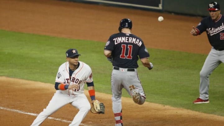 HOUSTON, TEXAS - OCTOBER 23: Ryan Zimmerman #11 of the Washington Nationals reaches first base safely against Yuli Gurriel #10 of the Houston Astros on a throw from Alex Bregman (not pictured) during the seventh inning in Game Two of the 2019 World Series at Minute Maid Park on October 23, 2019 in Houston, Texas. (Photo by Bob Levey/Getty Images)