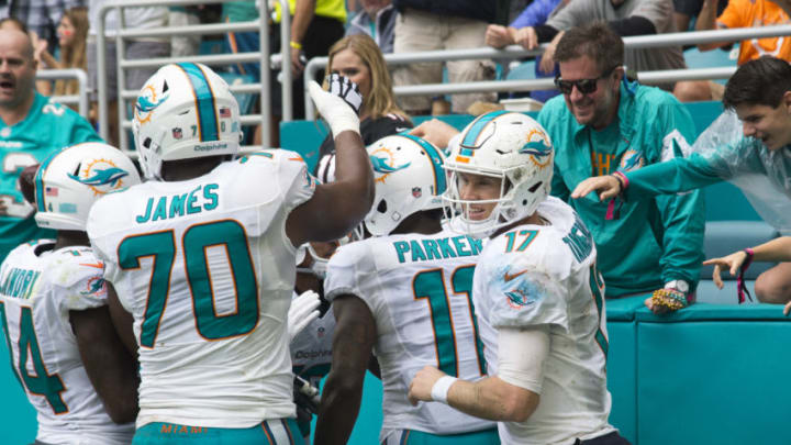 MIAMI GARDENS, FL - DECEMBER 11: Miami Dolphins Tight End Dion Sims (80) celebrates scoring a touchdown with Miami Dolphin fans and Miami Dolphins Quarterback Ryan Tannehill (17), Miami Dolphins Wide Receiver DeVante Parker (11), Miami Dolphins Offensive Tackle Ja'Wuan James (70), and Miami Dolphins Wide Receiver Jarvis Landry (14) during the NFL football game between the Arizona Cardinals and the Miami Dolphins on December 11, 2016, at the Hard Rock Stadium in Miami Gardens, FL. (Photo by Doug Murray/Icon Sportswire via Getty Images)