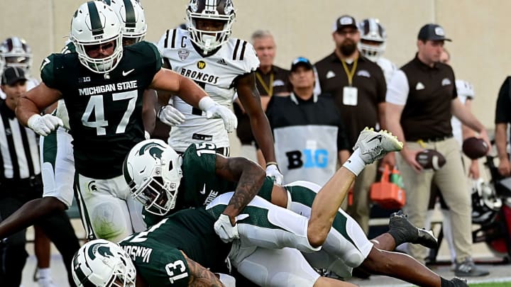 Sep 2, 2022; East Lansing, Michigan, USA; Michigan State Spartans linebacker Ben VanSumeren (13) and Michigan State Spartans safety Angelo Grose (15) tackle Western Michigan Broncos running back Sean Tyler (9) for a loss in the first quarter at Spartan Stadium during their game against Western Michigan University. Mandatory Credit: Dale Young-USA TODAY Sports