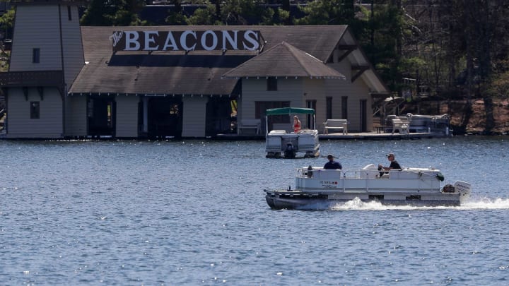 A pontoon boat motors across the water Wednesday on Minocqua Lake in Minocqua.NORTHWOODS22p2