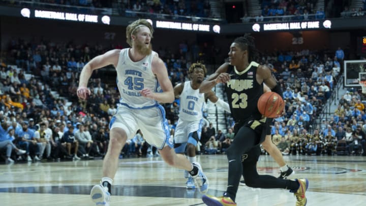 Nov 20, 2021; Uncasville, Connecticut, USA; Purdue Boilermakers guard Jaden Ivey (23) dribbles the ball toward the basket with North Carolina Tarheels forward Brady Manek (45) defending during the second half at Mohegan Sun Arena. Mandatory Credit: Gregory Fisher-USA TODAY Sports