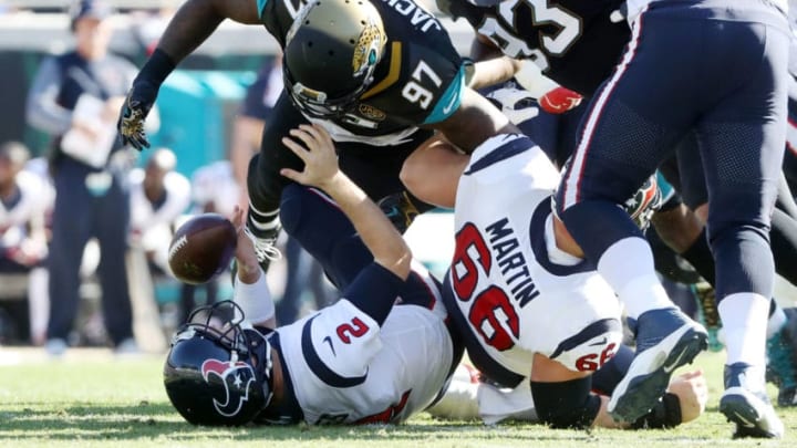 JACKSONVILLE, FL - DECEMBER 17: Malik Jackson #97 of the Jacksonville Jaguars sacks T.J. Yates #2 of the Houston Texans during the first half of their game at EverBank Field on December 17, 2017 in Jacksonville, Florida. (Photo by Sam Greenwood/Getty Images)