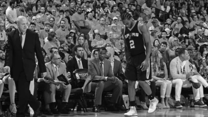 OAKLAND, CA – MAY 14: (EDITORS NOTE: Image has been converted to black and white.) Kawhi Leonard #2 of the San Antonio Spurs walks off the court in Game One of the Western Conference Finals against the Golden State Warriors during the 2017 NBA Playoffs on May 14, 2017 at ORACLE Arena in Oakland, California. NOTE TO USER: User expressly acknowledges and agrees that, by downloading and or using this photograph, user is consenting to the terms and conditions of Getty Images License Agreement. Mandatory Copyright Notice: Copyright 2017 NBAE (Photo by Noah Graham/NBAE via Getty Images)
