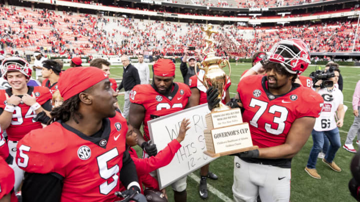 ATHENS, GA - NOVEMBER 26: Xavier Truss #73 of the Georgia Bulldogs holds the Governors Cup Trophy during a game between Georgia Tech Yellow Jackets and Georgia Bulldogs at Sanford Stadium on November 26, 2022 in Athens, Georgia. (Photo by Steve Limentani/ISI Photos/Getty Images)