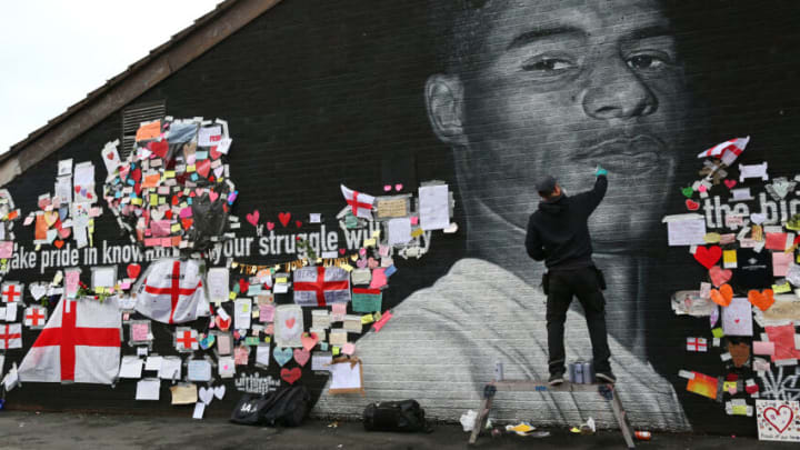 MANCHESTER, ENGLAND - JULY 13: A defaced mural of Marcus Rashford is repaired by the artist Akse P19 on July 13, 2021 in Manchester, England. Rashford and other Black players on England's national football team have been the target of racist abuse, largely on social media, after the team's loss to Italy in the UEFA European Football Championship last night. England manager Gareth Southgate, Prime Minister Boris Johnson, and the Football Association have issued statements condemning the abuse. (Photo by Alex Livesey - Danehouse/Getty Images)