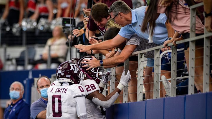 Sep 25, 2021; Arlington, Texas, USA; Texas A&M Aggies running back Isaiah Spiller (28) and wide receiver Ainias Smith (0) celebrate a touchdown against the Arkansas Razorbacks during the second half at AT&T Stadium. Mandatory Credit: Jerome Miron-USA TODAY Sports