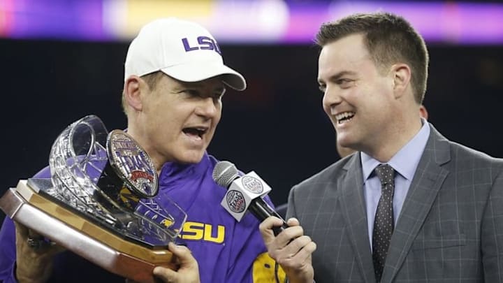 Dec 29, 2015; Houston, TX, USA; LSU Tigers head coach Les Miles (L) holds the Texas Bowl trophy after defeating the Texas Tech Red Raiders 56-27 at NRG Stadium. LSU won 56 to 27. Mandatory Credit: Thomas B. Shea-USA TODAY Sports