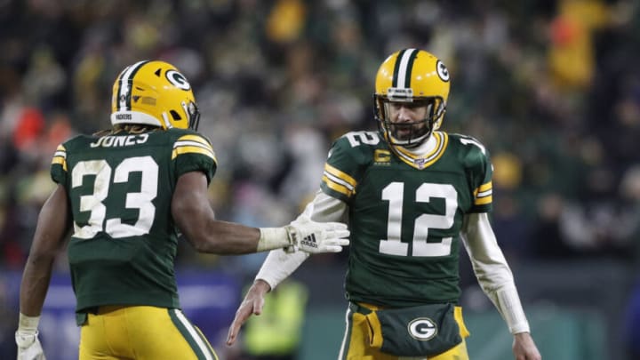 Jan 12, 2020; Green Bay, WI, USA; Green Bay Packers quarterback Aaron Rodgers (12) and running back Aaron Jones (33) celebrate a touchdown against the Seattle Seahawks in the third quarter of a NFC Divisional Round playoff football game at Lambeau Field. Mandatory Credit: Jeff Hanisch-USA TODAY Sports