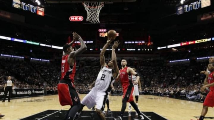 Dec 23, 2013; San Antonio, TX, USA; San Antonio Spurs forward Kawhi Leonard (2) attempts to shoot against Toronto Raptors forward Amir Johnson (15) during the first half at AT&T Center. Mandatory Credit: Soobum Im-USA TODAY Sports