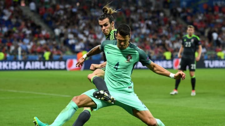 LYON, FRANCE - JULY 06: Gareth Bale of Wales battles for the ball with Jose Fonte of Portugal during the UEFA EURO 2016 semi final match between Portugal and Wales at Stade des Lumieres on July 6, 2016 in Lyon, France. (Photo by Michael Regan/Getty Images)