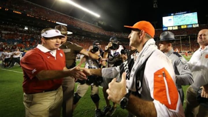 Dec 31, 2015; Miami Gardens, FL, USA; Clemson Tigers head coach Dabo Swinney shakes hands with Oklahoma Sooners head coach Bob Stoops during the fourth quarter of the 2015 CFP semifinal at the Orange Bowl at Sun Life Stadium. Clemson won 37-17. Mandatory Credit: Steve Mitchell-USA TODAY Sports