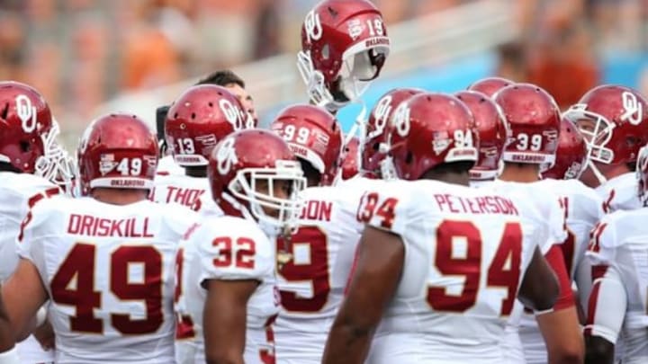 Oct 12, 2013; Dallas, TX, USA; Oklahoma Sooners huddle and raise a helmet prior to the game against the Texas Longhorns during the Red River Rivalry at the Cotton Bowl Stadium. Mandatory Credit: Matthew Emmons-USA TODAY Sports