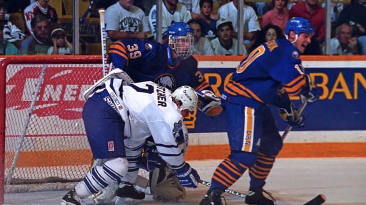 Garth Butcher #2 of the Toronto Maple Leafs, Dale Hawerchuk #10 and Dominik Hasak #29 of the Buffalo Sabres. (Photo by Graig Abel/Getty Images)