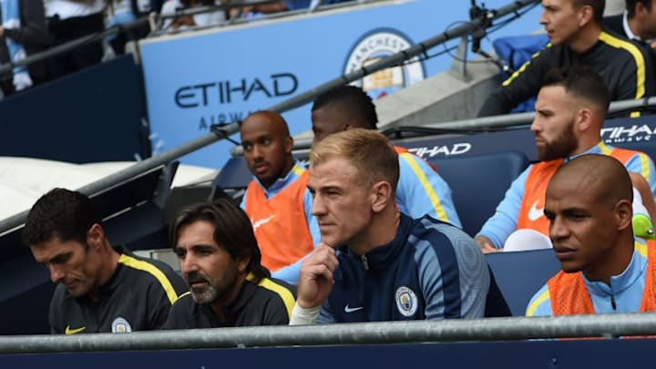 Manchester City's English goalkeeper Joe Hart (2R) sits on the substitutes bench for the English Premier League football match between Manchester City and Sunderland at the Etihad Stadium in Manchester, north west England, on August 13, 2016.Manchester City manager Pep Guardiola dropped goalkeeper Joe Hart in favour of Willy Caballero for his opening Premier League game against Sunderland on August 13. / AFP / PAUL ELLIS / RESTRICTED TO EDITORIAL USE. No use with unauthorized audio, video, data, fixture lists, club/league logos or 'live' services. Online in-match use limited to 75 images, no video emulation. No use in betting, games or single club/league/player publications. / (Photo credit should read PAUL ELLIS/AFP/Getty Images)