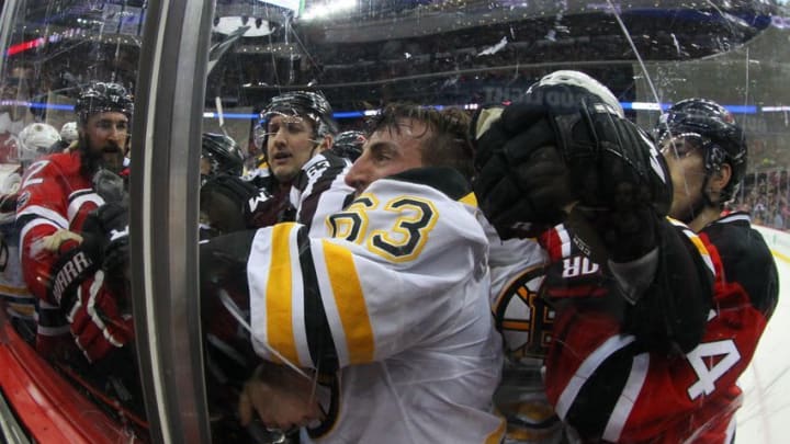 Jan 2, 2017; Newark, NJ, USA; New Jersey Devils defenseman Kyle Quincey (22) and Boston Bruins left wing Brad Marchand (63) are separated during the third period at Prudential Center. The Devils defeated the Bruins 3-0. Mandatory Credit: Ed Mulholland-USA TODAY Sports