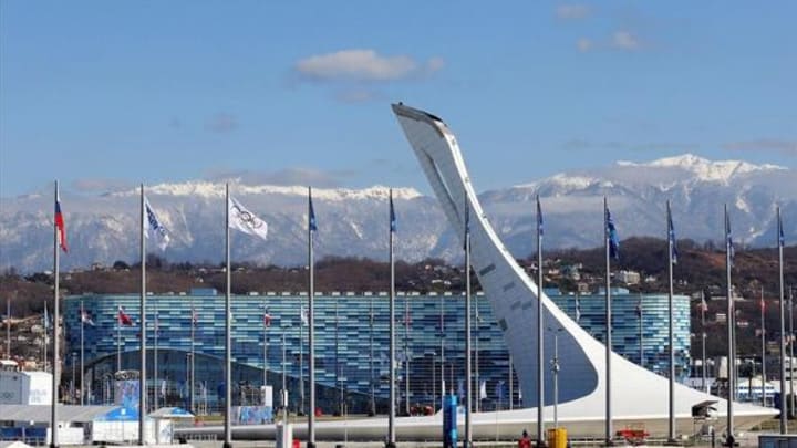 Feb 6, 2014; Sochi, RUSSIA; Flags fly outside the Iceberg Skating Palace and the Olympic cauldron prior to the start of the Sochi 2014 Olympic Winter Games. Mandatory Credit: Winslow Townson-USA TODAY Sports