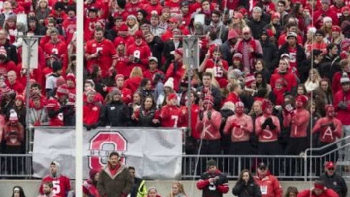 Nov 29, 2014; Columbus, OH, USA; Ohio State Buckeyes fans wear body paint saying "Find Kosta" in honor of missing Ohio State Buckeyes defensive lineman Kosta Karageorge (53) during the game against the Michigan Wolverines at Ohio Stadium. Ohio State won the game 42-28. Mandatory Credit: Greg Bartram-USA TODAY Sports