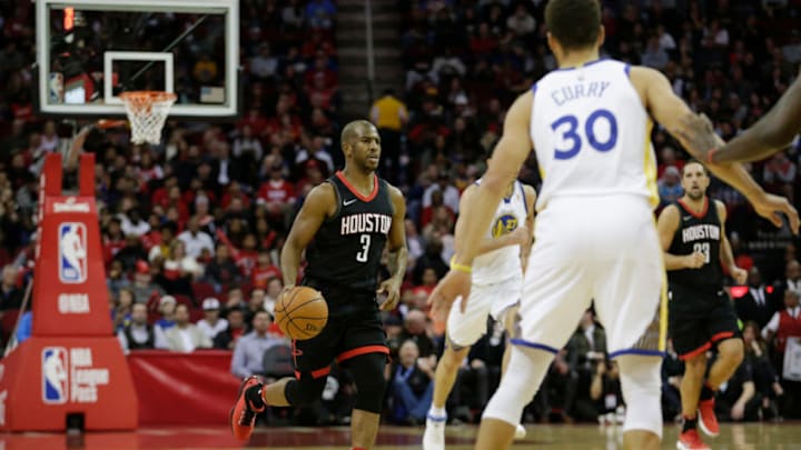 HOUSTON, TX - JANUARY 04: Chris Paul #3 of the Houston Rockets brings the ball down the court in the first half agains the Golden State Warriors at Toyota Center on January 4, 2018 in Houston, Texas. NOTE TO USER: User expressly acknowledges and agrees that, by downloading and or using this Photograph, user is consenting to the terms and conditions of the Getty Images License Agreement. (Photo by Tim Warner/Getty Images)