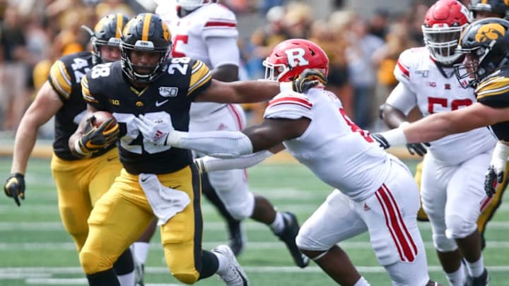 IOWA CITY, IOWA- SEPTEMBER 7: Running back Toren Young #28 of the Iowa Hawkeyes rushes up field during the first half past linebacker Tyshon Fogg #8 of the Rutgers Scarlet Knights on August 31, 2019 at Kinnick Stadium in Iowa City, Iowa. (Photo by Matthew Holst/Getty Images)