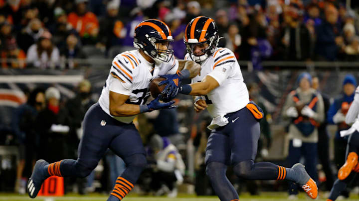 Dec 20, 2021; Chicago, Illinois, USA; Chicago Bears quarterback Justin Fields (1) hands the ball off to running back David Montgomery (32) against the Minnesota Vikings during the first quarter at Soldier Field. Mandatory Credit: Jon Durr-USA TODAY Sports