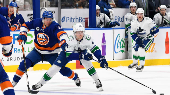 Mar 3, 2022; Elmont, New York, USA; Vancouver Canucks center Elias Pettersson (40) skates across the blue line defended by New York Islanders left wing Zach Parise (11) during the third period at UBS Arena. Mandatory Credit: Dennis Schneidler-USA TODAY Sports