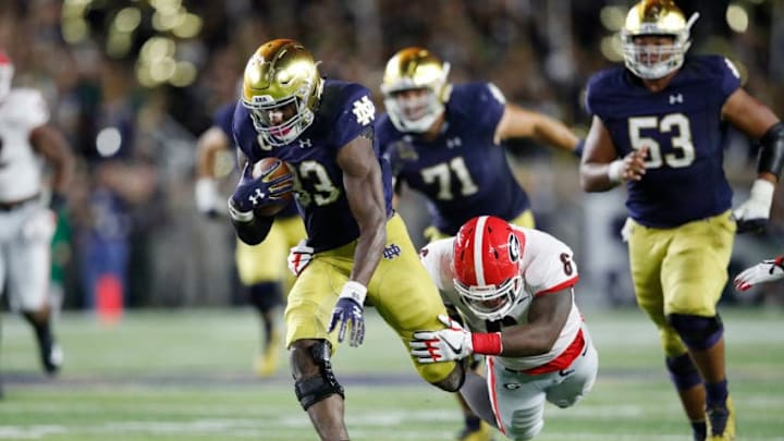 SOUTH BEND, IN - SEPTEMBER 09: Josh Adams #33 of the Notre Dame Fighting Irish runs through the tackle attempt from Natrez Patrick #6 of the Georgia Bulldogs in the second quarter of a game at Notre Dame Stadium on September 9, 2017 in South Bend, Indiana. (Photo by Joe Robbins/Getty Images)