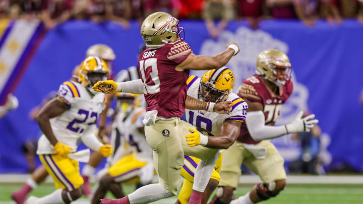 Sep 4, 2022; New Orleans, Louisiana, USA; Florida State Seminoles quarterback Jordan Travis (13) gets the pass off before being sacked by LSU Tigers defensive end BJ Ojulari (18) during the first half of the game at Caesars Superdome. Mandatory Credit: Stephen Lew-USA TODAY Sports