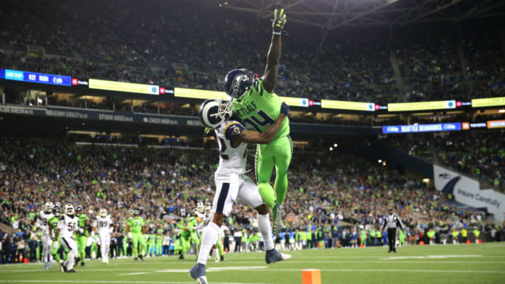 SEATTLE, WASHINGTON - OCTOBER 03: D.K. Metcalf #14 of the Seattle Seahawks reaches for an incomplete pass against Marcus Peters #22 of the Los Angeles Rams in the fourth quarter during their game at CenturyLink Field on October 03, 2019 in Seattle, Washington. (Photo by Abbie Parr/Getty Images)