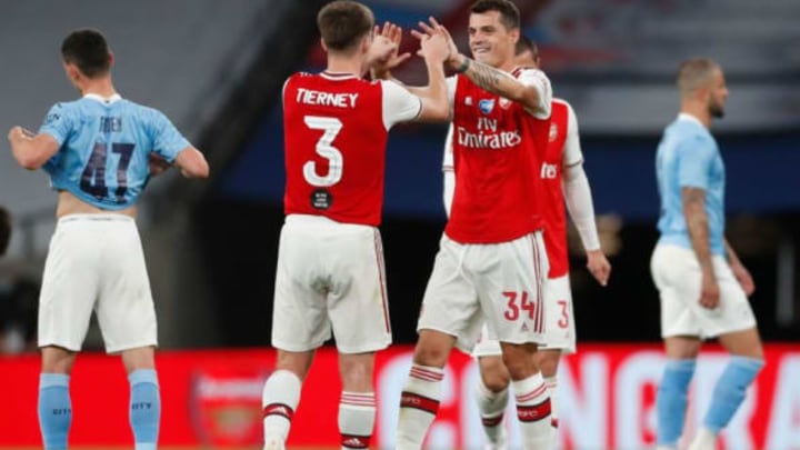 Arsenal’s Scottish defender Kieran Tierney (C) and Arsenal’s Swiss midfielder Granit Xhaka (R) celebrates at the end of the English FA Cup semi-final football match between Arsenal and Manchester City at Wembley Stadium in London, on July 18, 2020. (Photo by MATTHEW CHILDS / POOL / AFP) / NOT FOR MARKETING OR ADVERTISING USE / RESTRICTED TO EDITORIAL USE (Photo by MATTHEW CHILDS/POOL/AFP via Getty Images)