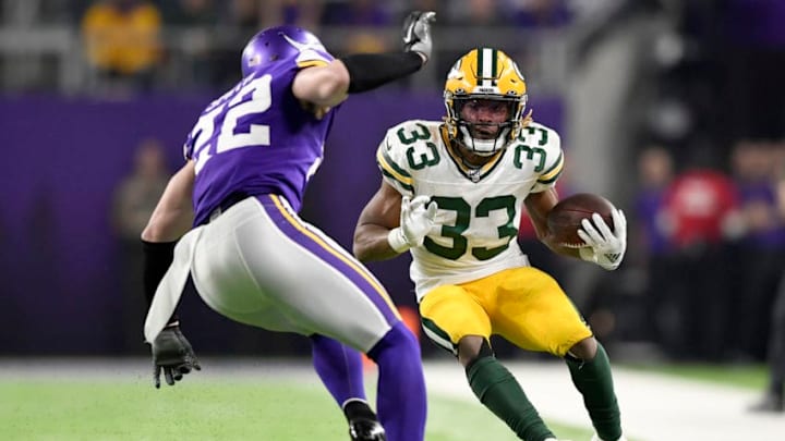 MINNEAPOLIS, MINNESOTA - DECEMBER 23: Running back Aaron Jones #33 of the Green Bay Packers carries the ball against free safety Harrison Smith #22 of the Minnesota Vikings during the game at U.S. Bank Stadium on December 23, 2019 in Minneapolis, Minnesota. (Photo by Hannah Foslien/Getty Images)