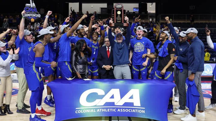 Mar 8, 2022; Washington, D.C., USA; Delaware Fightin Blue Hens head coach Martin Ingelsby holds the conference trophy and celebrates with the team after the Colonial Conference Championship game against the North Carolina-Wilmington Seahawks at Entertainment and Sports Arena. Mandatory Credit: Scott Taetsch-USA TODAY Sports