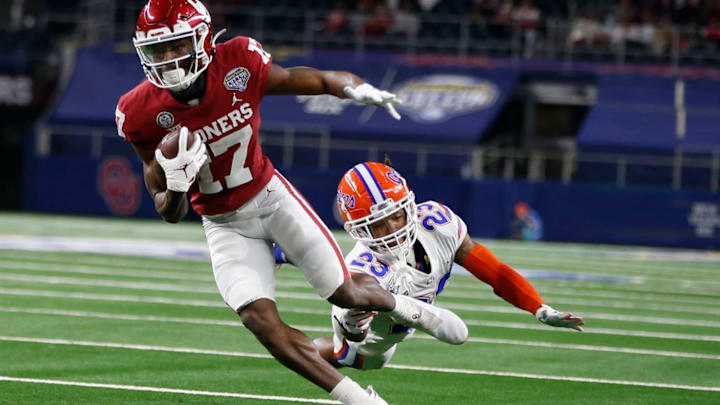 Dec 30, 2020; Arlington, TX, USA; Oklahoma Sooners wide receiver Marvin Mims (17) runs the ball against Florida Gators defensive back Jaydon Hill (23) in the game at ATT Stadium. Mandatory Credit: Tim Heitman-USA TODAY Sports