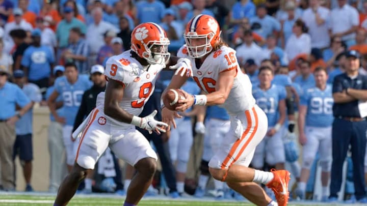 CHAPEL HILL, NORTH CAROLINA - SEPTEMBER 28: Trevor Lawrence #16 hands off to Travis Etienne #9 of the Clemson Tigers during their game against the North Carolina Tar Heels at Kenan Stadium on September 28, 2019 in Chapel Hill, North Carolina. Clemson won 21-20. (Photo by Grant Halverson/Getty Images)