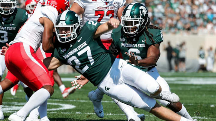 Michigan State linebacker Cal Haladay (27) triers to stop Youngstown State running back Jaleel McLaughlin (8) during the first half at Spartan Stadium in East Lansing on Saturday, Sept. 11, 2021.