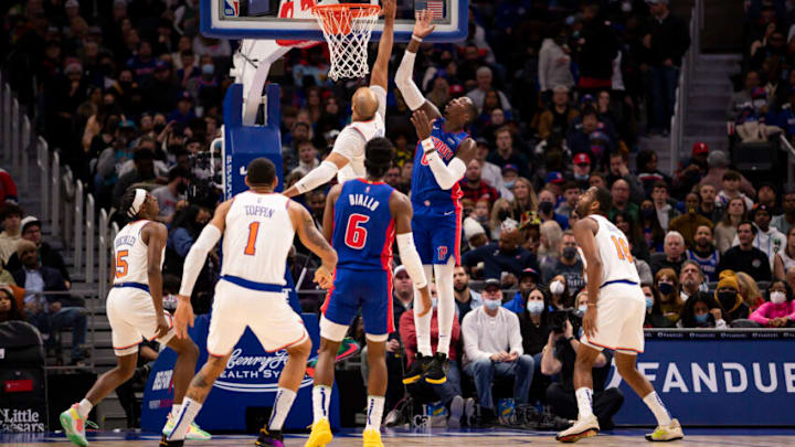 Dec 29, 2021; Detroit, Michigan, USA; Detroit Pistons forward Cheick Diallo (00) gets his shot blocked by New York Knicks center Taj Gibson (67) during the second quarter at Little Caesars Arena. Mandatory Credit: Raj Mehta-USA TODAY Sports