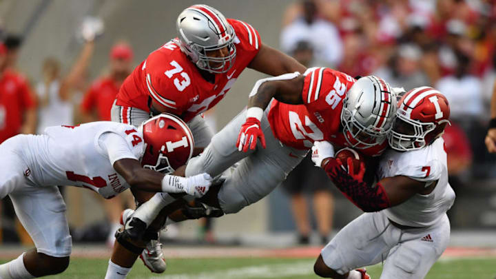 COLUMBUS, OH - OCTOBER 6: Mike Weber #25 of the Ohio State Buckeyes is hauled down by Andre Brown Jr. #14 of the Indiana Hoosiers and Reakwon Jones #7 of the Indiana Hoosiers in the third quarter at Ohio Stadium on October 6, 2018 in Columbus, Ohio. (Photo by Jamie Sabau/Getty Images)