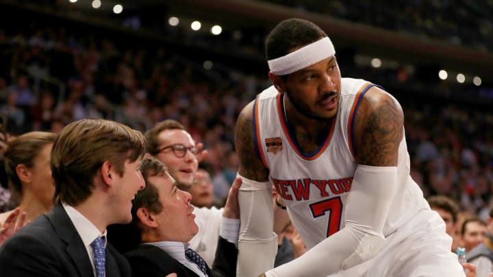 NEW YORK, NY – APRIL 12: Carmelo Anthony #7 of the New York Knicks falls into the crowd as he goes after a ball in the first quarter against the Philadelphia 76ers at Madison Square Garden on April 12, 2017 in New York City. NOTE TO USER: User expressly acknowledges and agrees that, by downloading and or using this Photograph, user is consenting to the terms and conditions of the Getty Images License Agreement (Photo by Elsa/Getty Images)