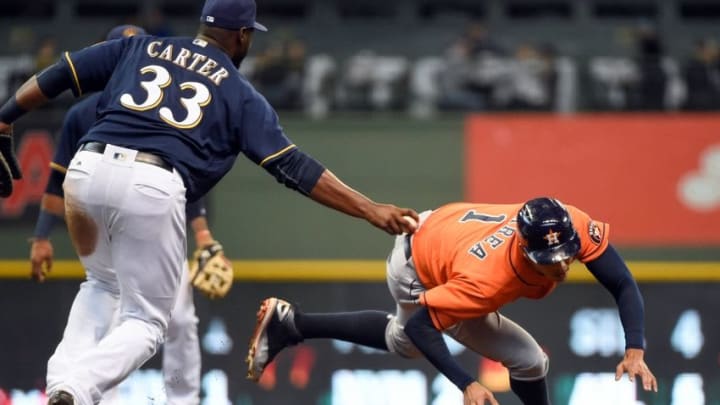 Apr 10, 2016; Milwaukee, WI, USA; Houston Astros shortstop Carlos Correa (1) is tagged out by Milwaukee Brewers first baseman Chris Carter (33) after being picked off first base in the fourth inning at Miller Park. Mandatory Credit: Benny Sieu-USA TODAY Sports