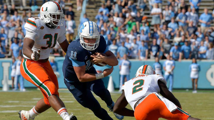 CHAPEL HILL, NC – OCTOBER 28: Demetrius Jackson #31 and Trajan Bandy #2 of the Miami Hurricanes tackle Nathan Elliott #11 of the North Carolina Tar Heels during their game at Kenan Stadium on October 28, 2017 in Chapel Hill, North Carolina. (Photo by Grant Halverson/Getty Images)