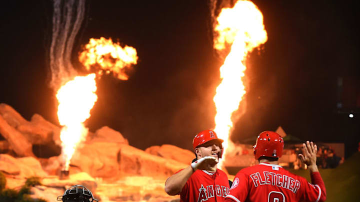 ANAHEIM, CA - JULY 25: Omar Narvaez #38 of the Chicago White Sox looks on as Mike Trout #27 of the Los Angeles Angels of Anaheim is greeted by David Fletcher #6 of the Los Angeles Angels of Anaheim after hitting a three run home run in the sixth inning against the Chicago White Sox at Angel Stadium on July 25, 2018 in Anaheim, California. (Photo by Jayne Kamin-Oncea/Getty Images)