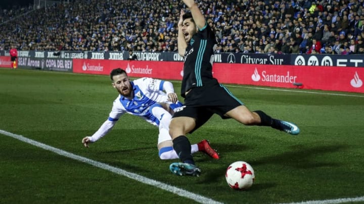 LEGANES, SPAIN - JANUARY 18: Marco Asensio (R) of Real Madrid CF cis tackled by Roberto Roman Triguero alias Tito (L) of Deportivo Leganes during the Copa del Rey quarter final first leg match between Real Madrid CF and Club Deportivo Leganes at Estadio Municipal de Butarque on January 18, 2018 in Leganes, Spain. (Photo by Gonzalo Arroyo Moreno/Getty Images)