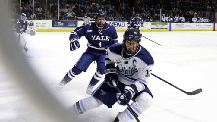 PORTLAND, ME - JANUARY 7: UMaine's Chase Pearson takes possession of the puck at the boards while Yale's Matt Foley defends. (Staff photo by Ben McCanna/Portland Press Herald via Getty Images)