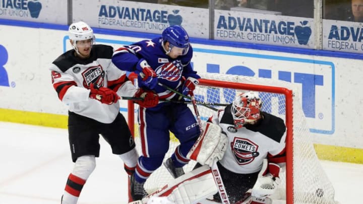 Amerks Brandon Biro redirects a shot past Utica goalie Akira Schmid. Rochester won in OT 4-3.