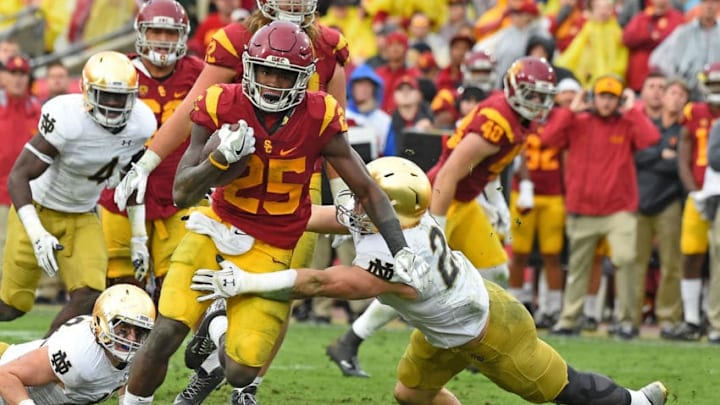 LOS ANGELES, CA - NOVEMBER 26: Ronald Jones II #25 of the USC Trojans gets by Drue Tranquill #23 of the Notre Dame Fighting Irish for a gain in the fourth quarter of the game at the Los Angeles Memorial Coliseum on November 26, 2016 in Los Angeles, California. USC won 45-27. (Photo by Jayne Kamin-Oncea/Getty Images)