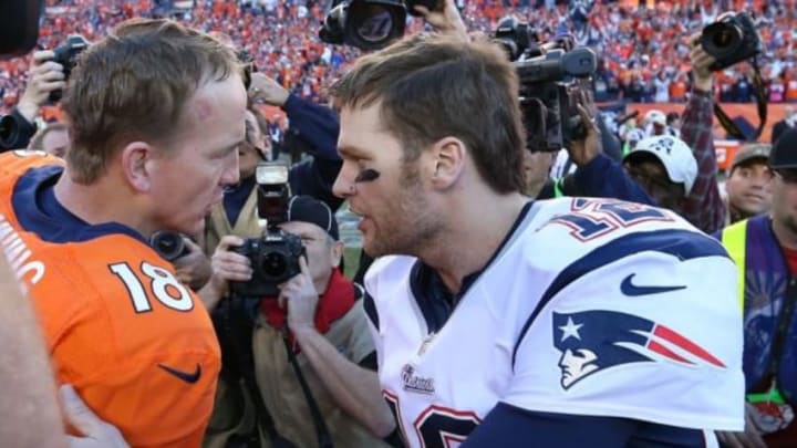 Jan 19, 2014; Denver, CO, USA; Denver Broncos quarterback Peyton Manning (18) meets with New England Patriots quarterback Tom Brady (12) after the 2013 AFC Championship game at Sports Authority Field at Mile High. Mandatory Credit: Matthew Emmons-USA TODAY Sports