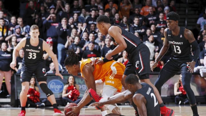 CINCINNATI, OH - DECEMBER 18: Yves Pons #35 of the Tennessee Volunteers tries to gather a loose ball against Keith Williams #2 and Mika Adams-Woods #3 of the Cincinnati Bearcats in the first half of the game at Fifth Third Arena on December 18, 2019 in Cincinnati, Ohio. (Photo by Joe Robbins/Getty Images)